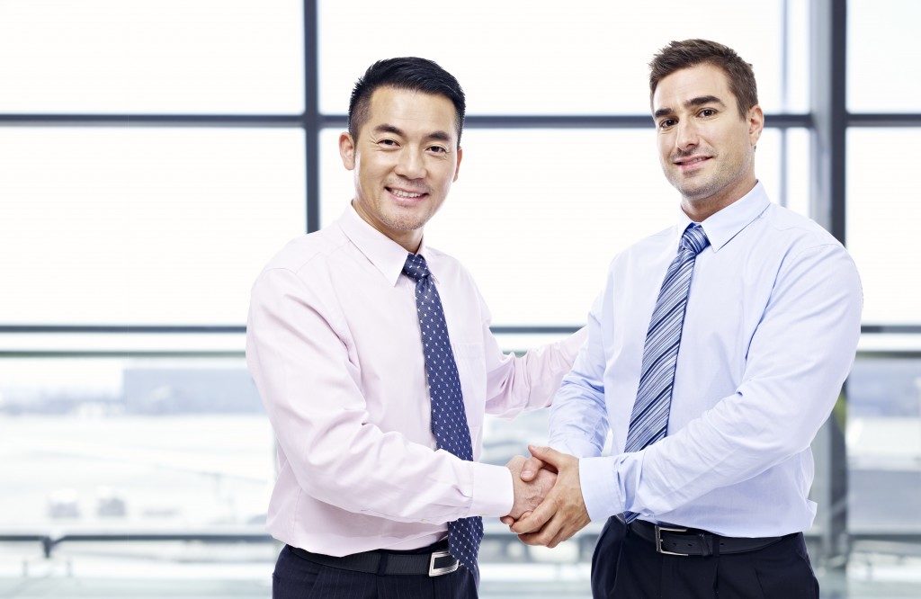 Asian and caucasian businessmen shaking hands