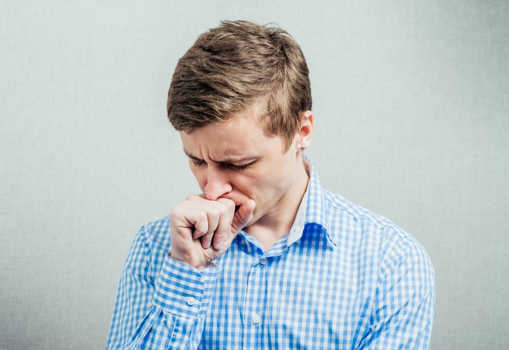 man coughing
