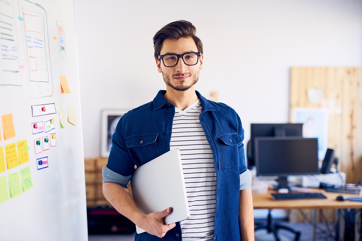 man carrying laptop at the office