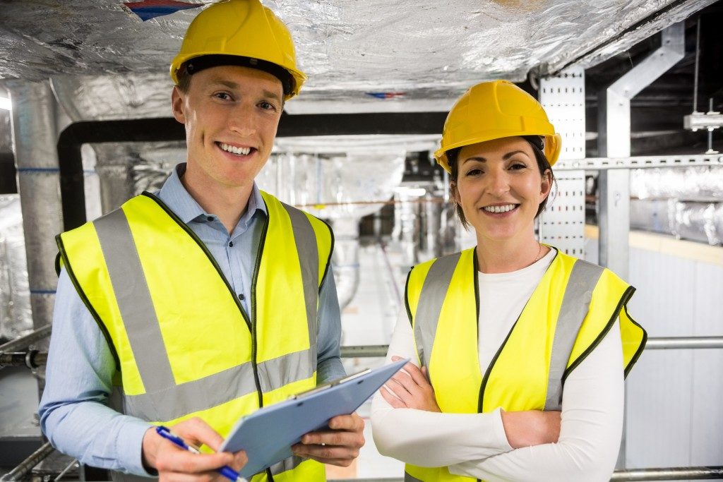 Man and woman worker wearing fluorescent vests