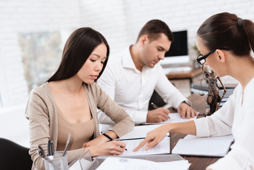 couple filing and signing divorce papers