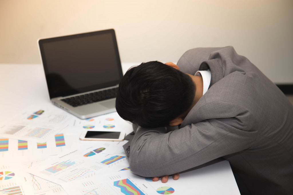 man sleeping in desk