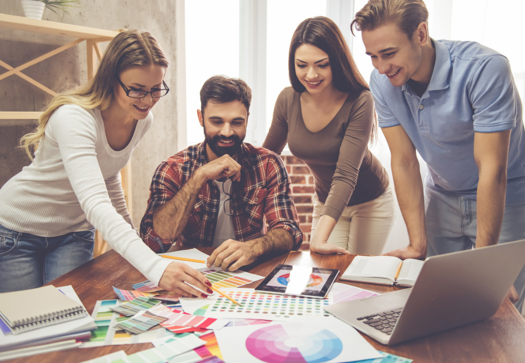 Two female and two males working together in office shows positive work culture