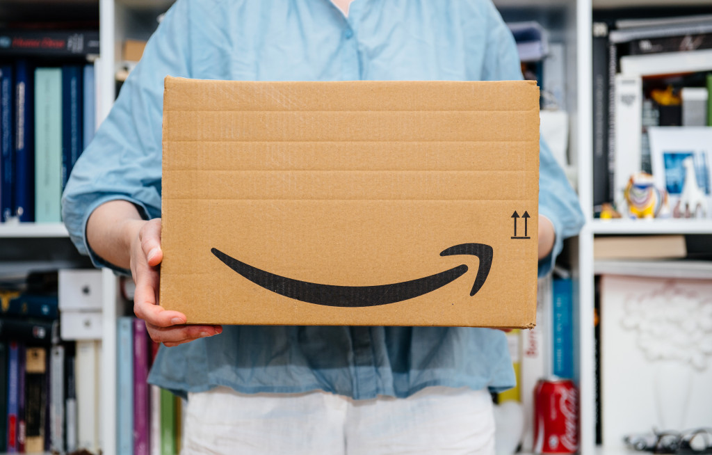 A man carrying an Amazon box