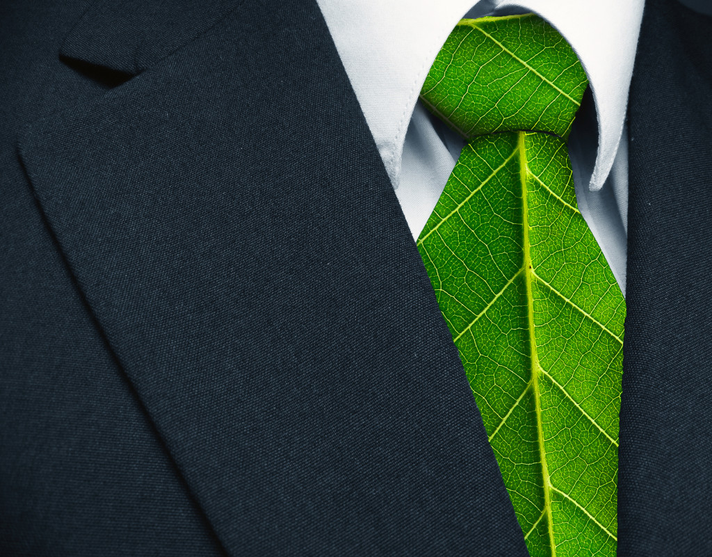 Business suit and green leaves as tie representing a natural job in defense of a green environment.