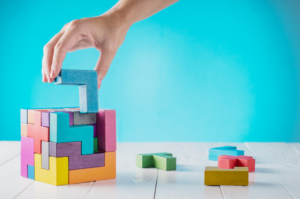 A hand completing a puzzle block