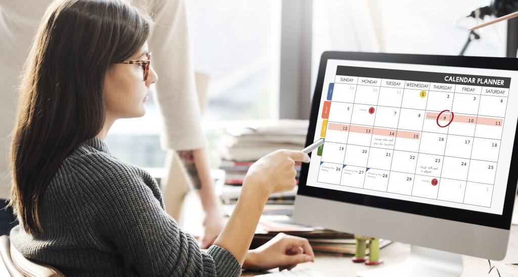 A woman checking an online calendar