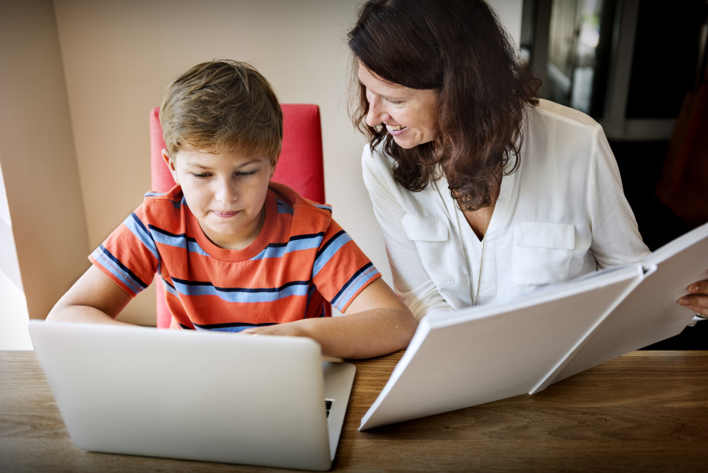 woman tutoring a little boy