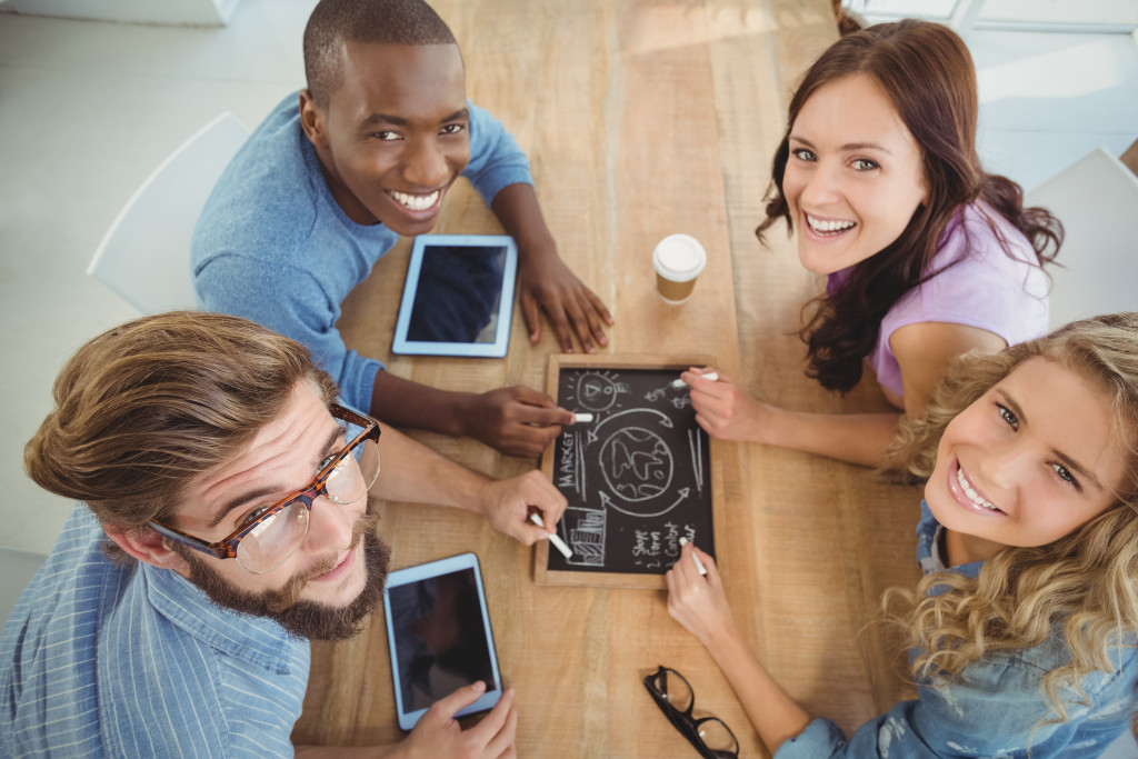 Diverse group of employees discussing a project in an office.