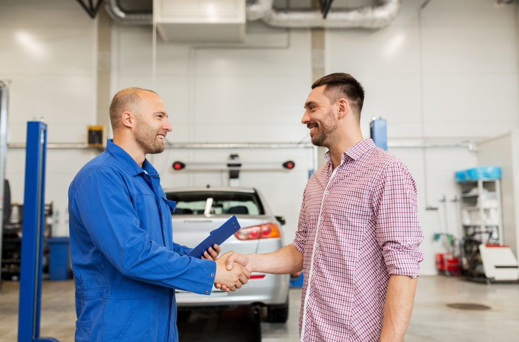 mechanic talking to a satisfied customer