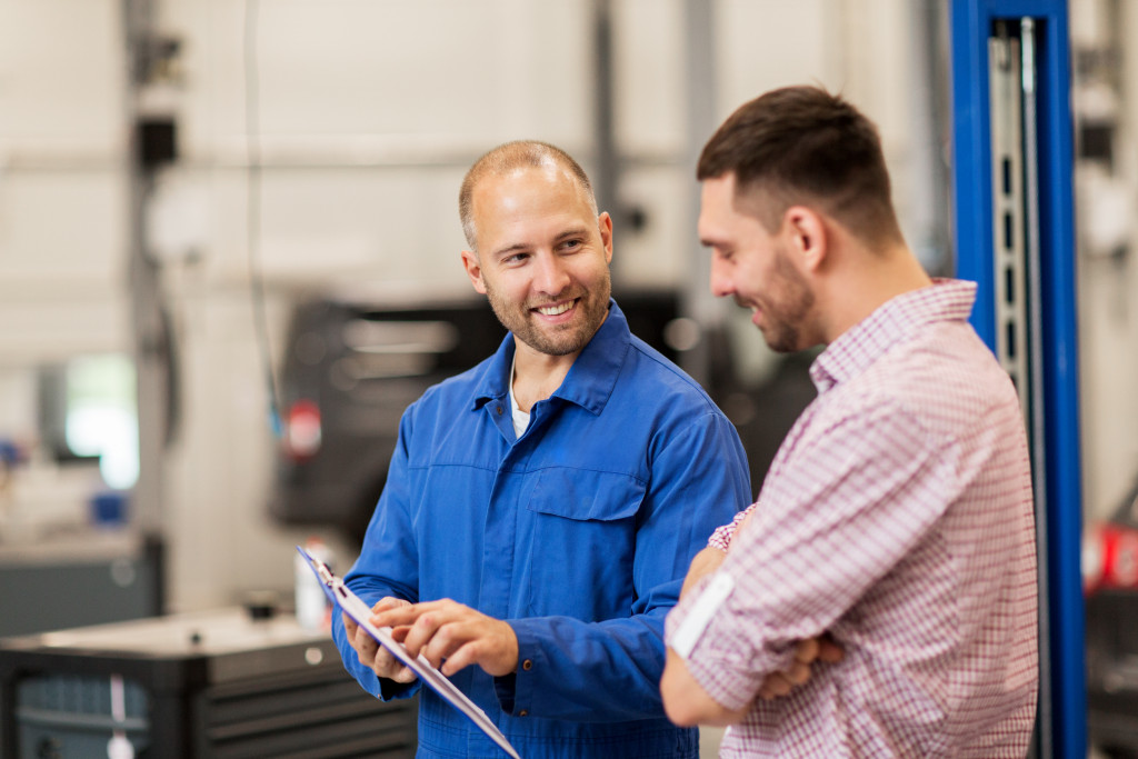 a customer talking to an auto mechanic