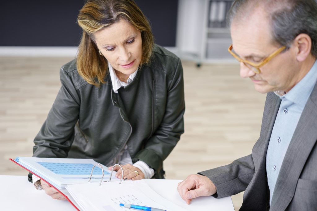 businessman looking at files and papers 