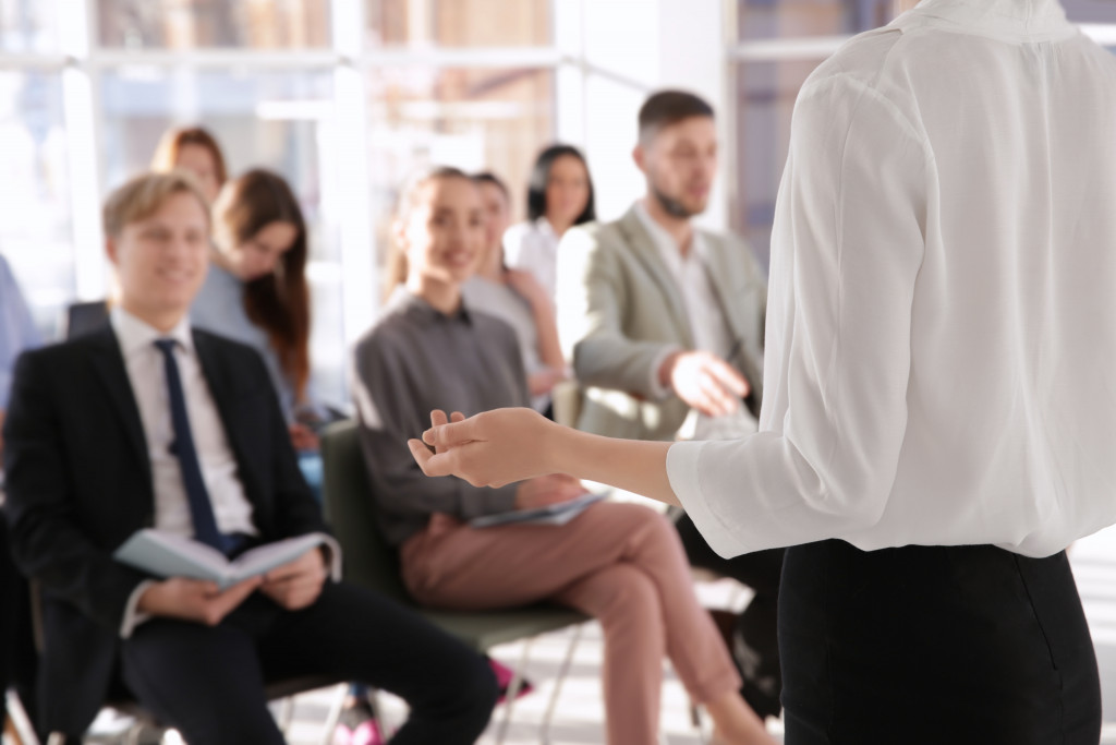 man training employees in seminar or workshop