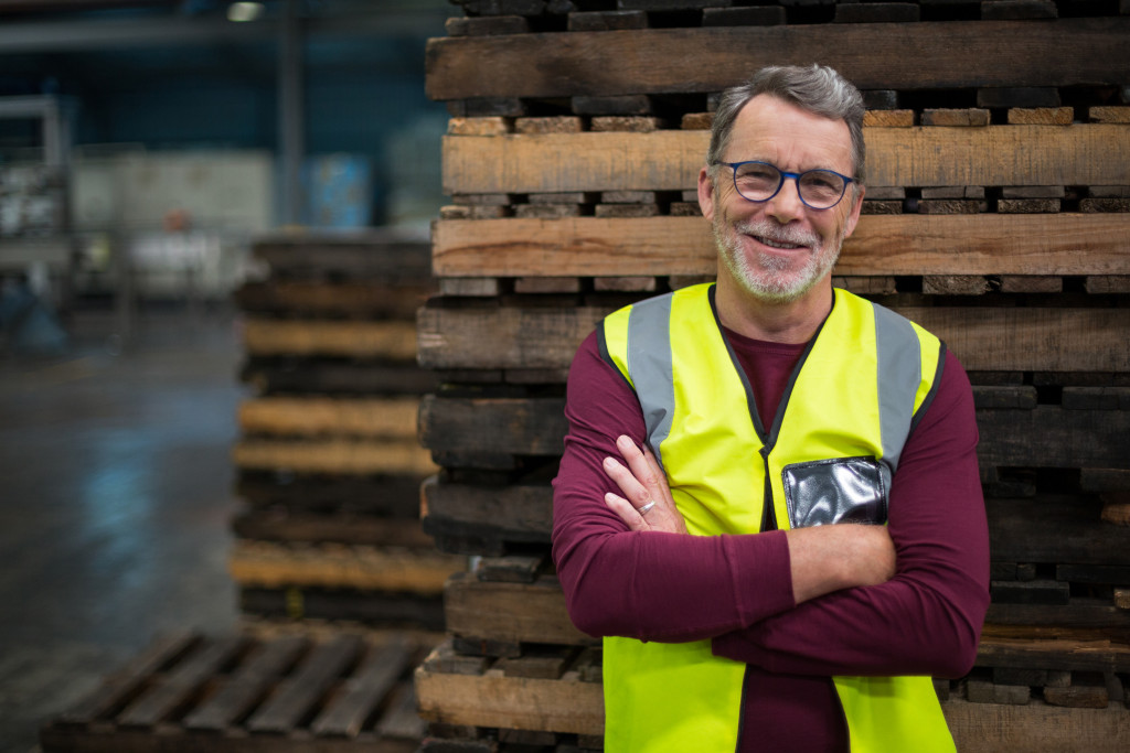 A factory worker smiling to the camera