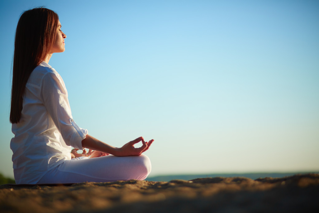 A woman doing yoga outdoors