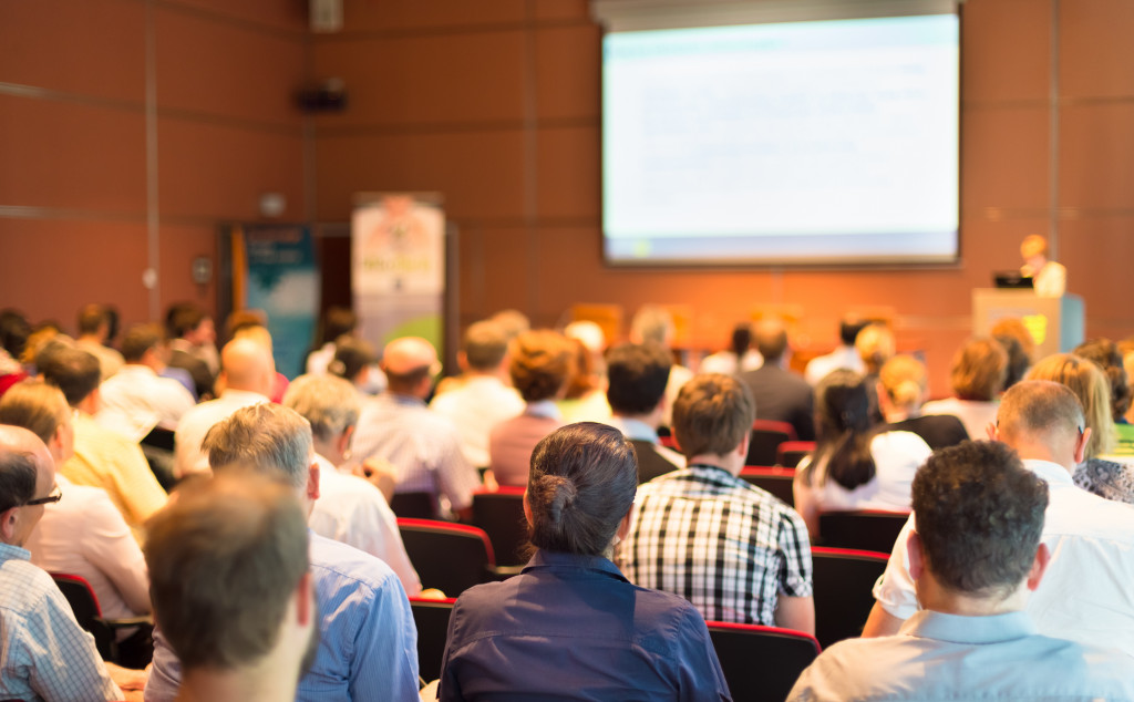 a group of aspiring business people listening at a business conference