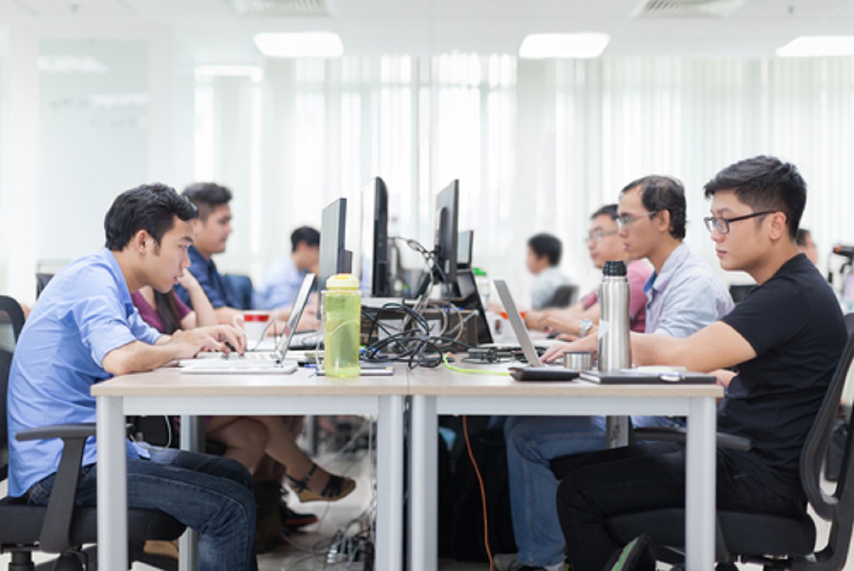 Employees working in an office with an open layout in Singapore.
