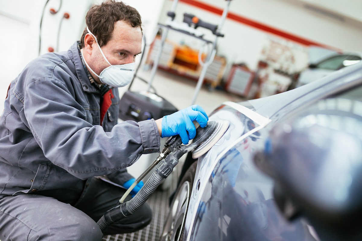 auto detailer at work buffing car