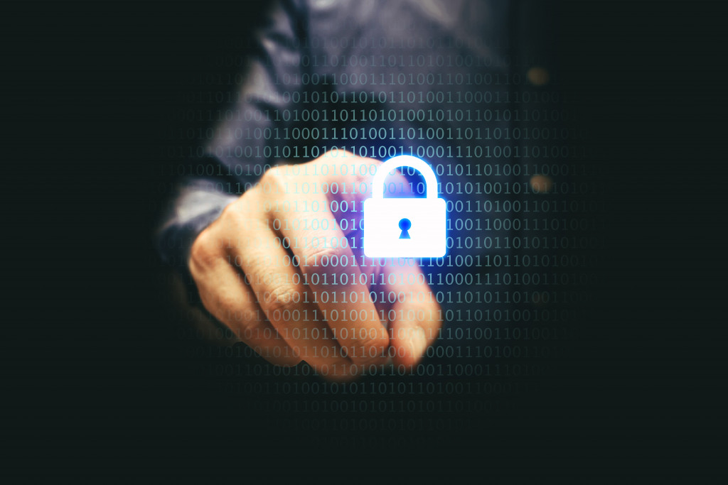 A businessman pressing a padlock button